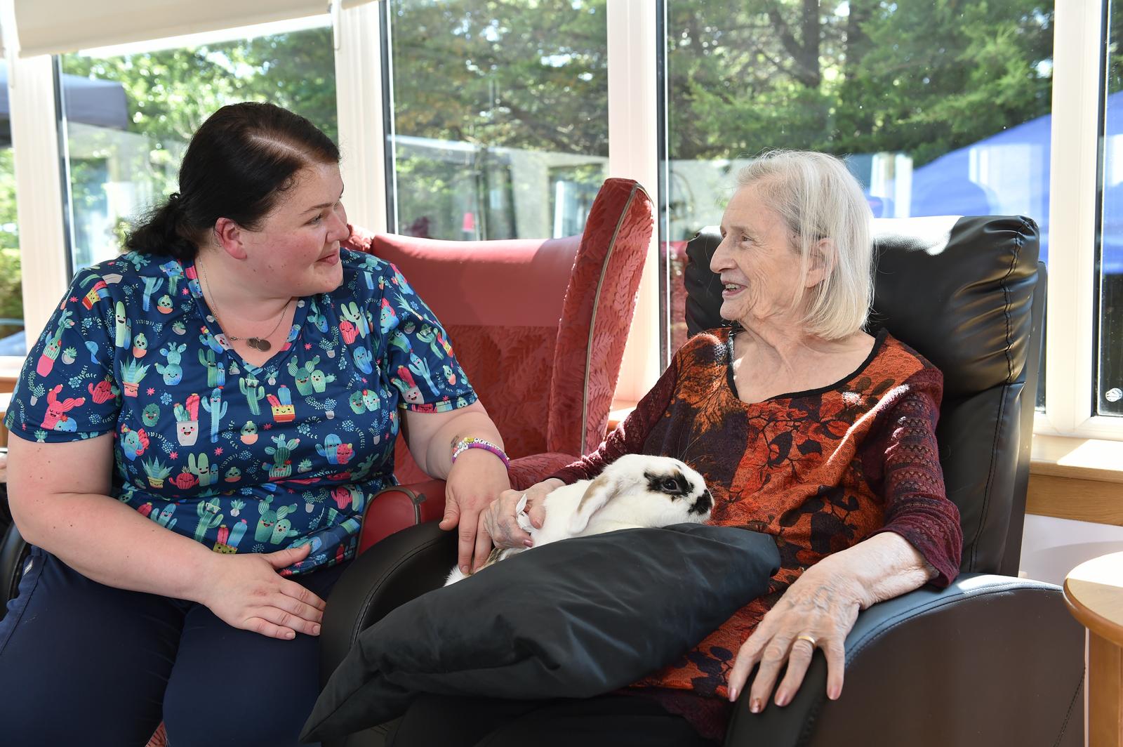 A carer providing compassionate support to a resident
