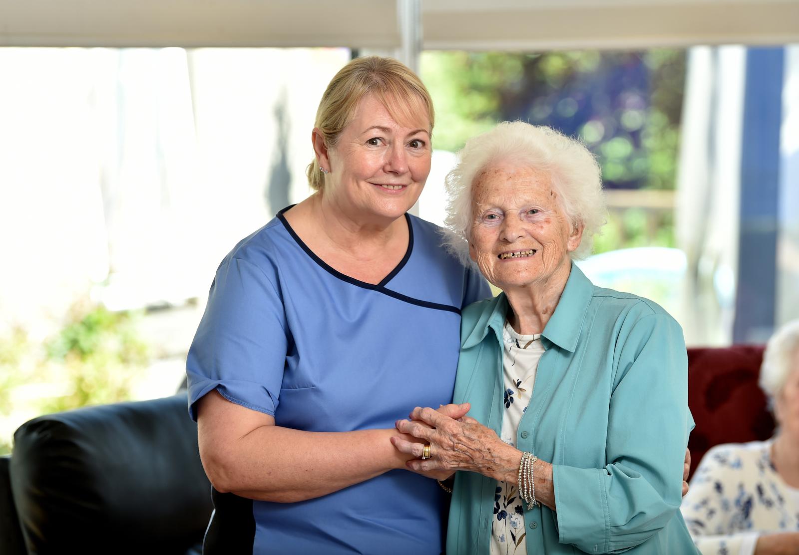 A family visiting a resident in a comfortable lounge